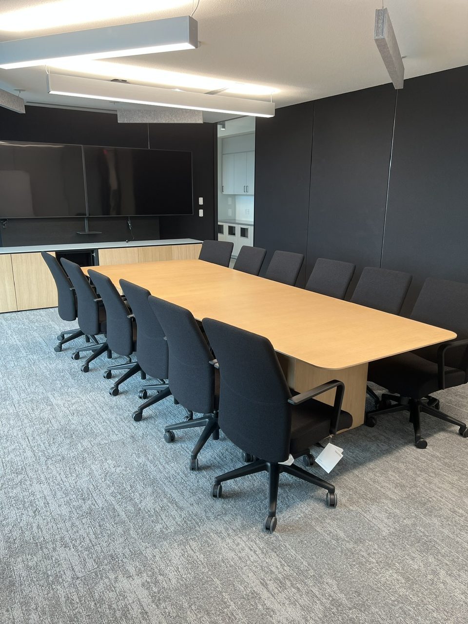 Installed conference room with a large wood table and seating