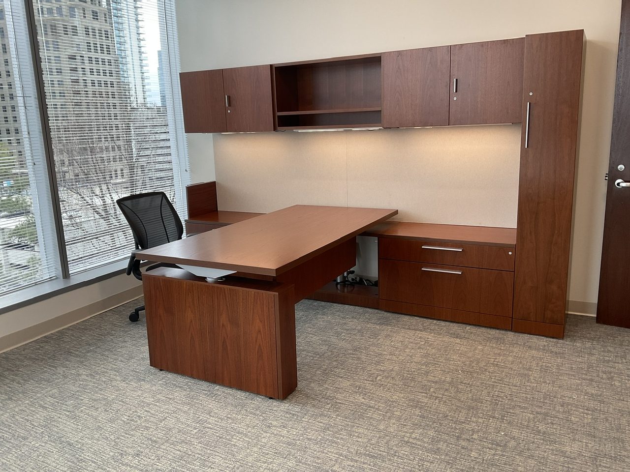 Installed private executive office with a wood desk and storage